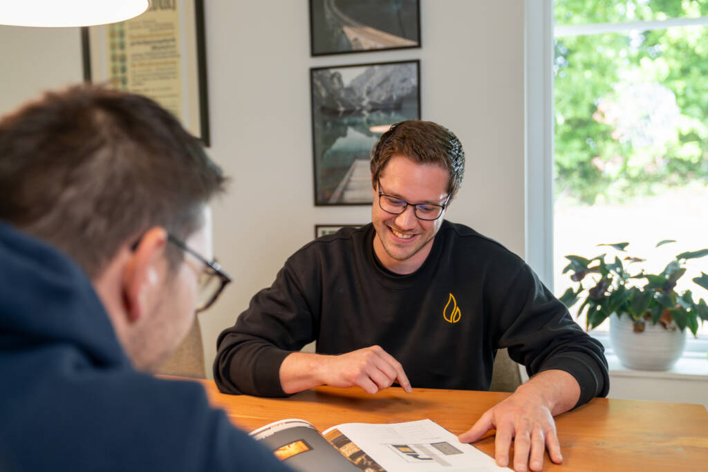 Ofenbau Münster Daniel Ickerott bei der Planung am Tisch mit einem Kunden
